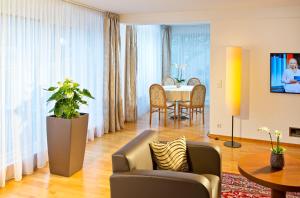 a living room with a couch and a table at Hotel Penz West in Innsbruck