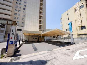 an empty parking lot in front of a building at Hotel JAL City Nagasaki in Nagasaki