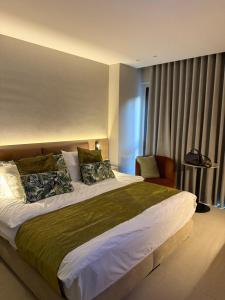 a bedroom with a large bed and a chair at Local Sursock in Beirut