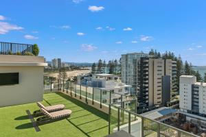 a balcony with a view of a city at Luxury Esprit Apartment at Rainbow Bay in Gold Coast