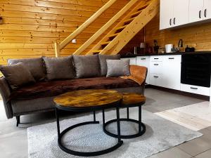 a living room with a couch and a table at W lesie nad rzeką in Rolbik