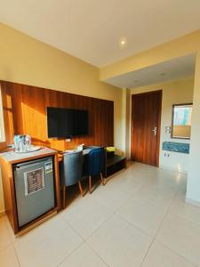 a living room with a television and a table and chairs at Sama Hotel Oraby in Cairo