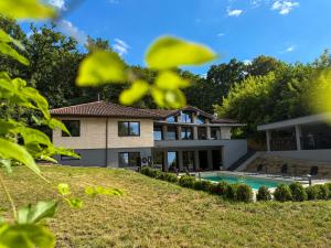 an exterior view of a house with a swimming pool at Breite Privée Forest and Pool Retreat in Sighişoara
