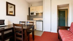 a living room with a dining room table and a kitchen at Virginia N108 - 2P4 in Grasse