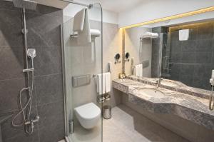 a bathroom with a toilet and a sink and a shower at Rai Foresta Tekirova & SPA in Kemer +34 photos