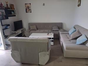 a living room with a couch and a table at Apartman Miljan in Trebinje