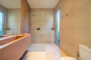 a bathroom with a shower and a sink and a toilet at Matahari House in Nusa Lembongan +54 photos