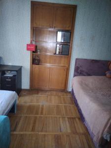 a room with two beds and a wooden door at Lalo in Tbilisi City