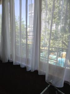 a window with white curtains in a room at Lalo in Tbilisi City