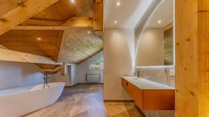 a bathroom with a white sink and wooden ceilings at Villa Panoramique - Lac du Bourget in Bourdeau +94 photos