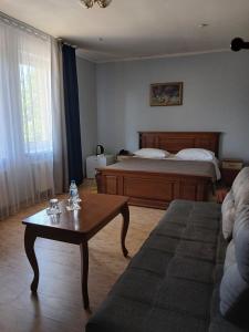 a living room with a bed and a coffee table at Casablanca Hotel in Kalush +33 photos