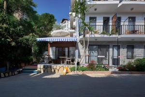 a building with an umbrella in front of it at CARETTA PANSİYOn in Kaş