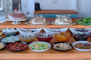 a buffet with many different types of food in bowls at CARETTA PANSİYOn in Kaş +53 photos
