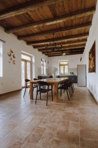 a kitchen and dining room with a table and chairs at Nizija in Sombor