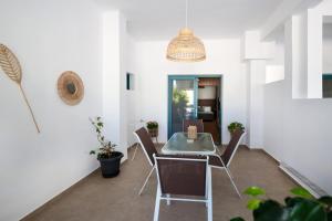 a dining room with a table and chairs at Galaxias Studios in Skala