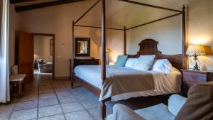 a bedroom with a large canopy bed in a room at Agroturisme Son Cardaix in Artá +74 photos