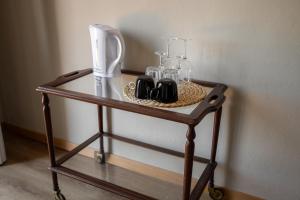 a table with glasses and bottles on top of it at Bohemian Palace Florence in Florence