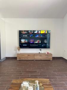 a living room with a flat screen tv on a wall at Apartment Panger in Izola