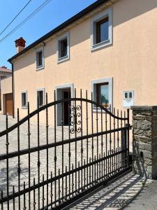 a black fence in front of a house at Apartment Panger in Izola