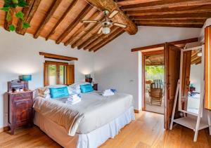 a bedroom with a bed and a ceiling fan at Vicinato Homestead in Molazzana +70 photos