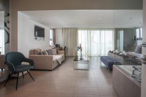 a living room with a couch and a table at Atlantis Boutique City Hotel in Rhodes Town