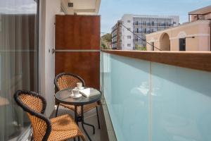 a small table and two chairs on a balcony at Atlantis Boutique City Hotel in Rhodes Town