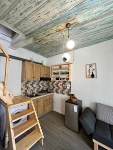 a kitchen with a wooden ceiling and a table at Happiness skopelos in Glossa +24 photos