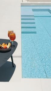 a table with a bowl of fruit next to a pool at Asterry Suites in Kimolos