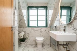 a bathroom with a sink and a toilet and a mirror at A beautiful mews house in a city centre in Edinburgh +21 photos