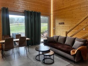 a living room with a couch and a table at W lesie nad rzeką in Rolbik