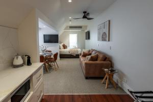 a kitchen and living room with a couch and a bed at Camden Hotel Suites in Camden