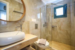 a bathroom with a toilet and a sink and a shower at Galaxias Studios in Skala +32 photos