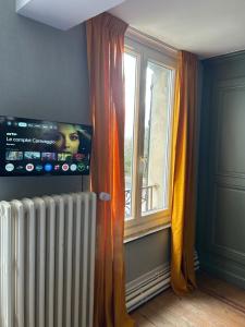 a living room with a radiator and a window at Vallee du Ton in Origny-en-Thiérache