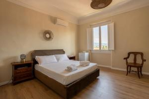 a bedroom with a bed and a window and a chair at Bohemian Palace Florence in Florence