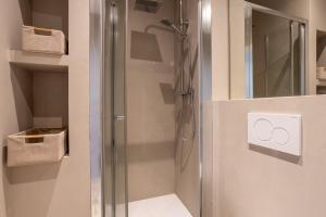 a bathroom with a shower with a glass door at Bohemian Palace Florence in Florence +44 photos