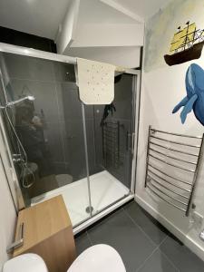 a shower stall in a bathroom with a toilet at 1 Marine House in Penzance