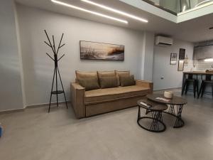 a living room with a couch and a table at Alkaiou Loft in Kalamata
