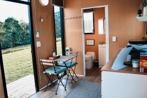 a small kitchen with a table and chairs in a room at Pasture and Paws by Tiny Away in Leeville