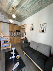 a living room with a couch and a table at Happiness skopelos in Glossa
