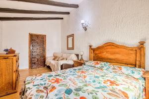 a bedroom with a bed with a colorful bedspread at La Adrada Green Escape with pool in La Adrada