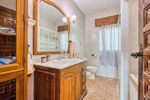 a bathroom with a sink and a toilet at La Adrada Green Escape with pool in La Adrada