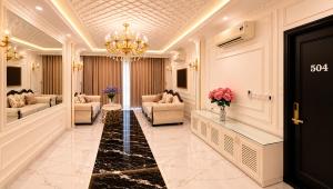 a lobby with couches and a chandelier at D'Élite Boutique Hotel Dĩ An in Dĩ An