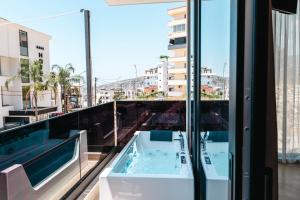 a hot tub on the balcony of a building at Heavenly Rest Luxury Hotel in Sarandë
