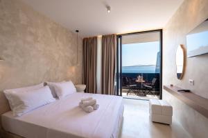 a bedroom with a white teddy bear sitting on a bed at Heavenly Rest Luxury Hotel in Sarandë +288 photos