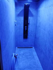 a bathroom with a shower with blue lighting at L'Échappée Romantique & Spa Privatif in Foix