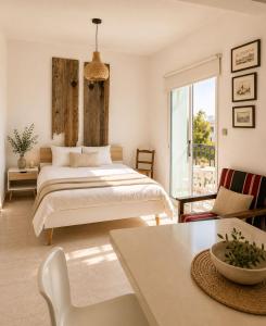 a bedroom with a bed and a large window at PanMari in Paphos