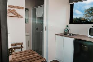 a small kitchen with a sink and a microwave at Hills and Herds by Tiny Away in Shannon Brook +13 photos