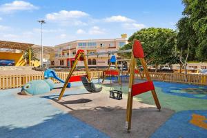 a playground with a swing set in a park at Villa Gabriela in Tarajalejo