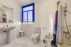 a bathroom with a toilet and a sink and a shower at Villa Gabriela in Tarajalejo +19 photos