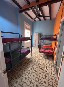 a room with two bunk beds and a window at Tarragona Rooms 4 in Tarragona